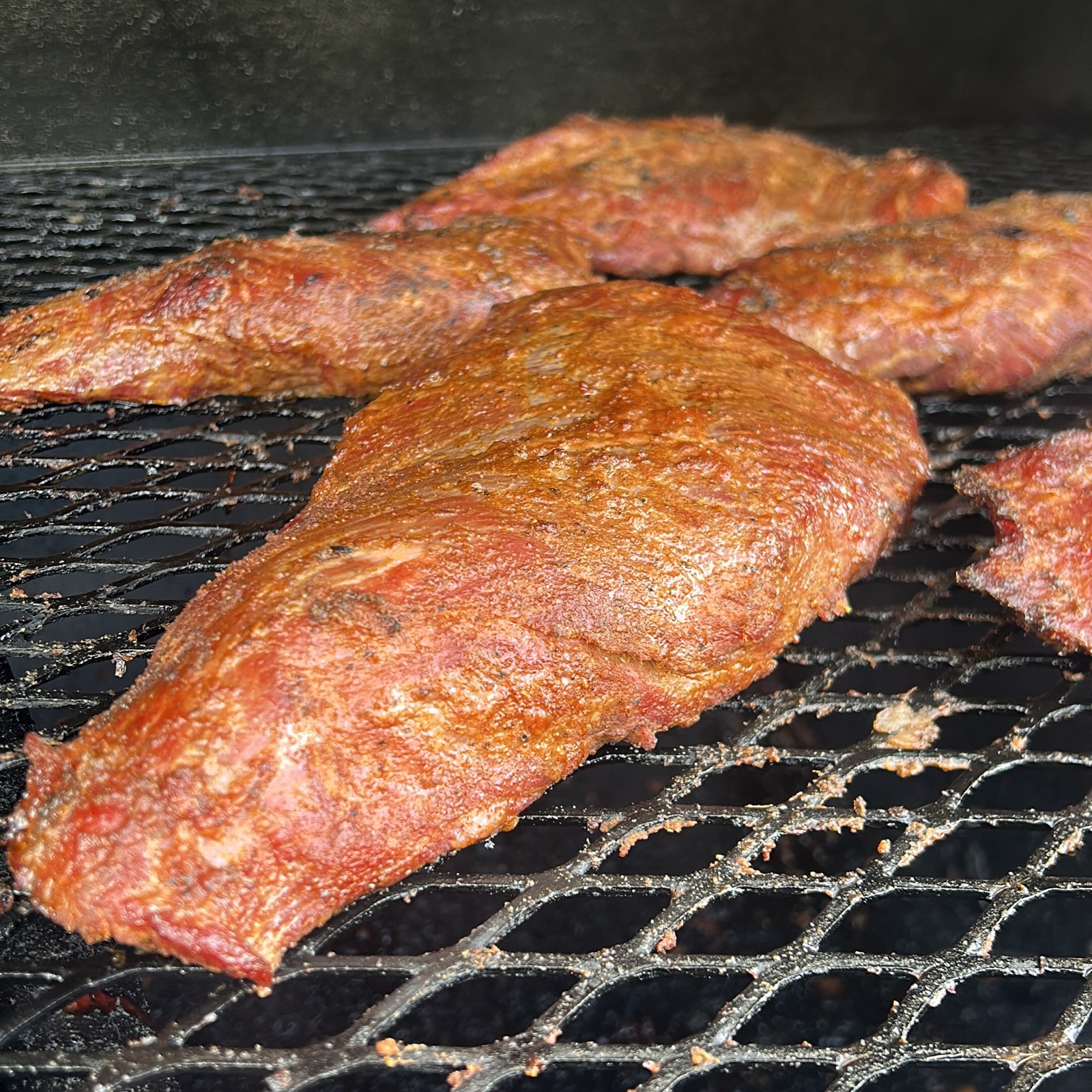 Seasoned tri tip roast on the grate